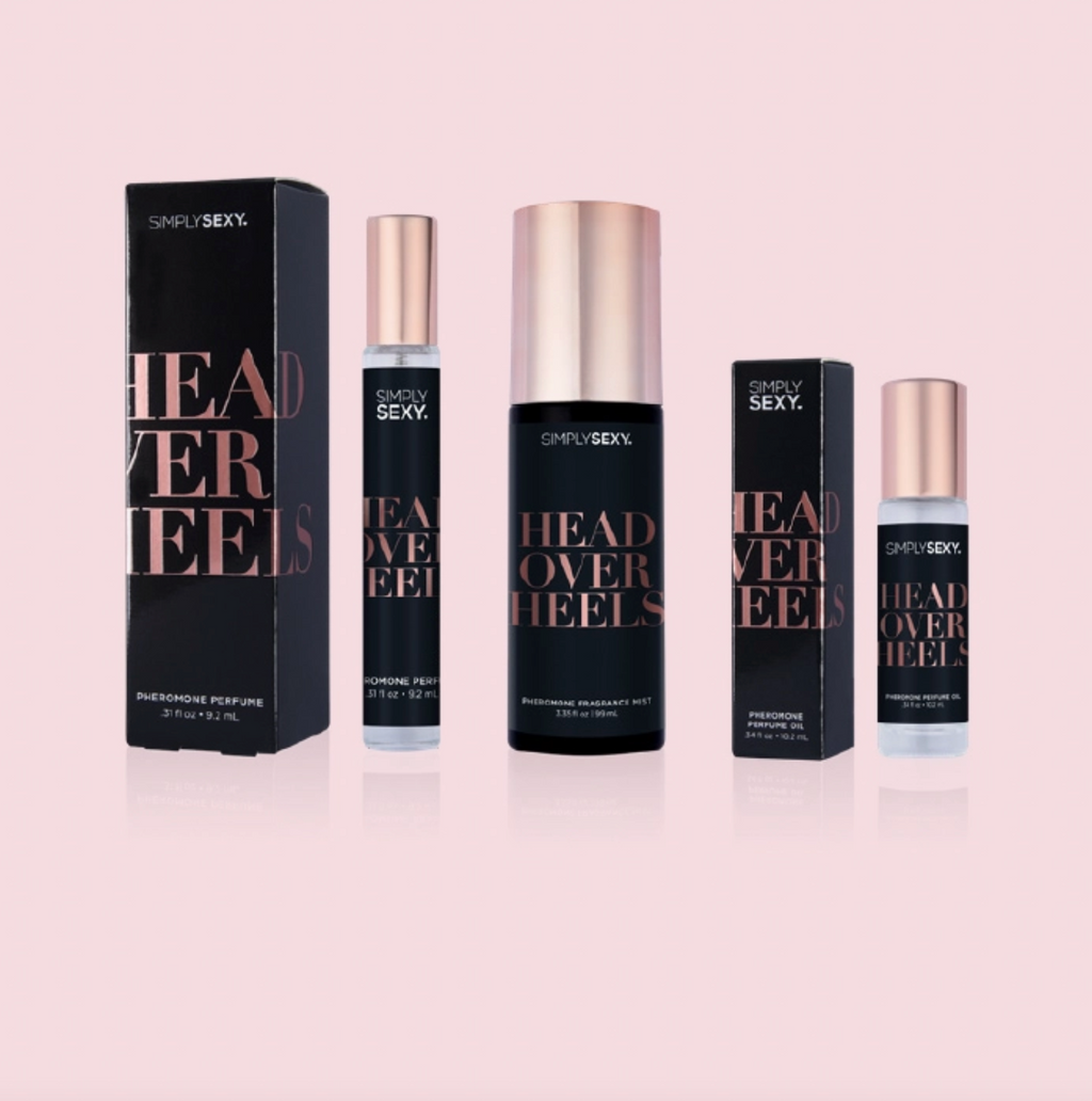 Perfume bottles and packaging of 'Simply Sexy Head Over Heels' on a pink background